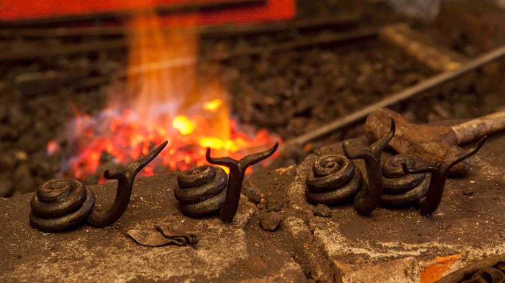 Iron snail art, made in the forge at Finch Foundry, Devon